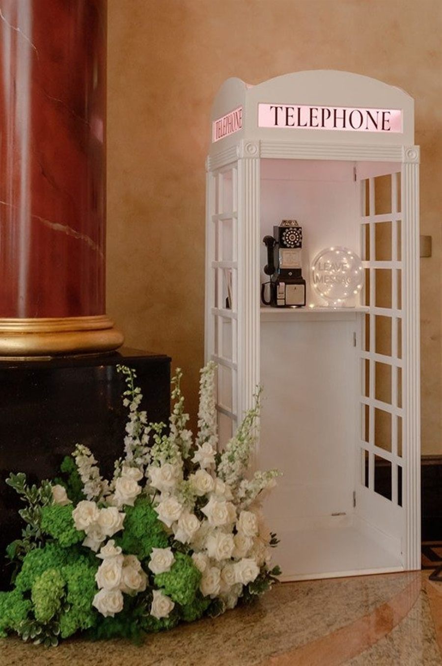 Full-size white British phone booth